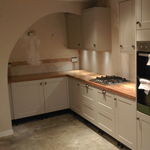 Shaker style cabinets with oak worktops and belfast sink