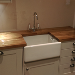 Shaker style cabinets with oak worktops and belfast sink