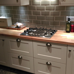 Shaker style cabinets with oak worktops and belfast sink